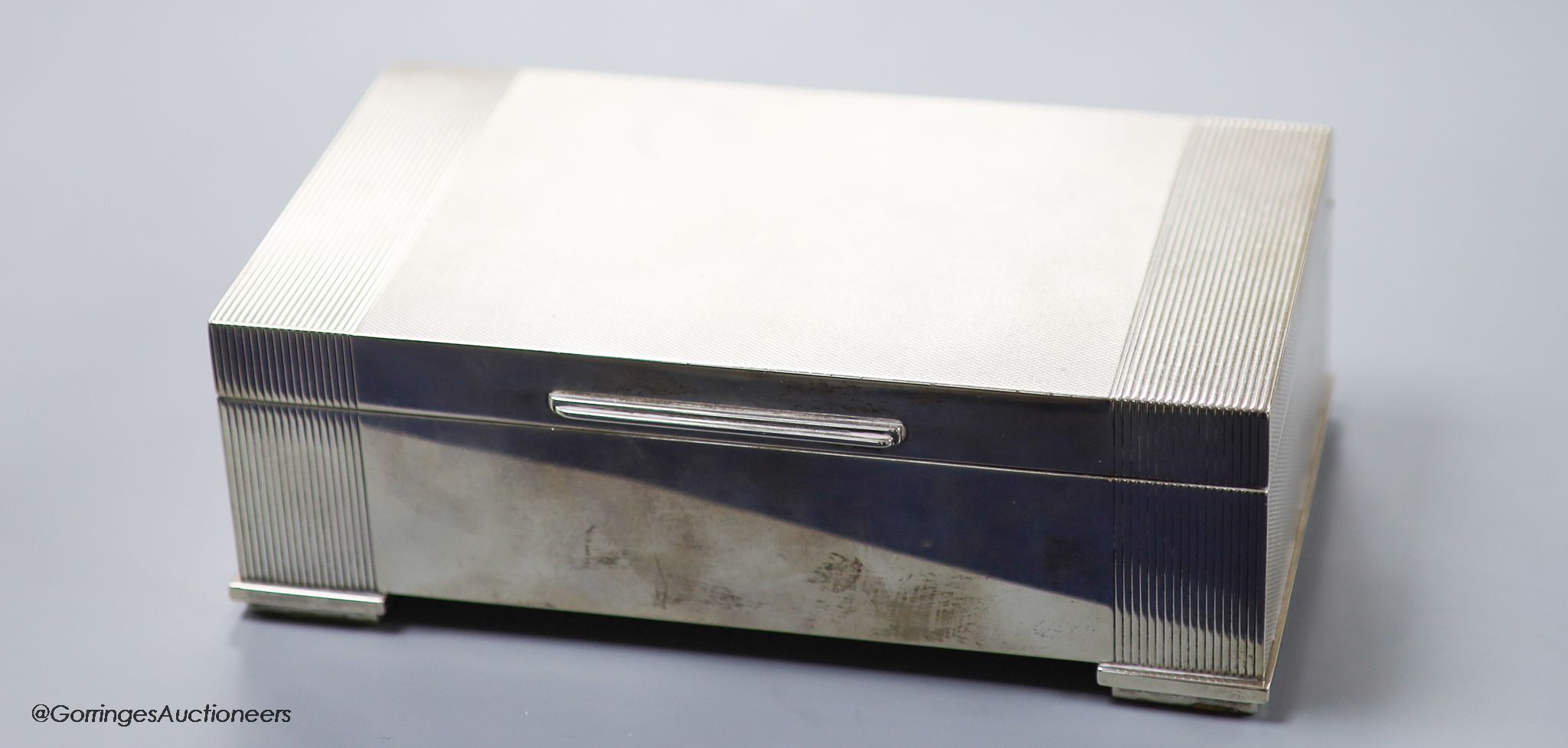 An engine-turned silver rectangular cigarette box, by Garrard & Co Ltd,